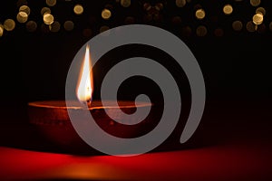 Happy Diwali - Clay Diya lamps lit during Dipavali, Hindu festival of lights celebration