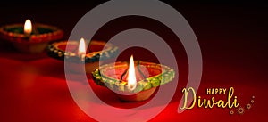 Happy Diwali - Clay Diya lamps lit during Dipavali, Hindu festival of lights celebration