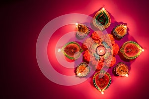 Happy Diwali - Clay Diya lamps lit during Dipavali, Hindu festival of lights celebration. Colorful traditional oil lamp diya on