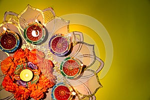 Happy Diwali - Clay Diya lamps lit during Dipavali, Hindu festival of lights celebration. Colorful traditional oil lamp diya on