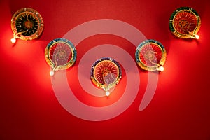 Happy Diwali - Clay Diya lamps lit during Dipavali, Hindu festival of lights celebration. Colorful traditional oil lamp diya on