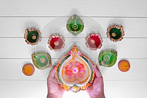 Happy Diwali - Clay Diya lamps lit during Dipavali, Hindu festival of lights celebration. Colorful traditional oil lamp diya on