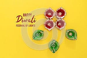 Happy Diwali - Clay Diya lamps lit during Dipavali, Hindu festival of lights celebration. Colorful traditional oil lamp diya