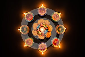 Happy Diwali - Clay Diya lamps lit during Dipavali, Hindu festival of lights celebration. Colorful traditional oil lamp diya on