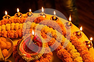 Happy Diwali - Clay Diya lamps lit during Dipavali, Hindu festival of lights celebration. Colorful traditional oil lamp diya and