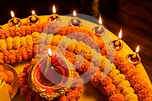 Happy Diwali - Clay Diya lamps lit during Dipavali, Hindu festival of lights celebration. Colorful traditional oil lamp diya and