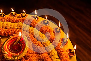 Happy Diwali - Clay Diya lamps lit during Dipavali, Hindu festival of lights celebration. Colorful traditional oil lamp diya and