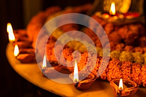 Happy Diwali - Clay Diya lamps lit during Dipavali, Hindu festival of lights celebration. Colorful traditional oil lamp diya and