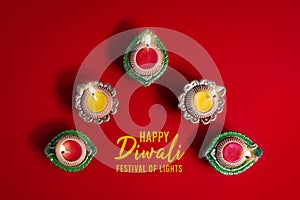 Happy Diwali - Clay Diya lamps lit during Dipavali, Hindu festival of lights celebration. Colorful traditional oil lamp diya