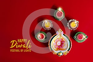 Happy Diwali - Clay Diya lamps lit during Dipavali, Hindu festival of lights celebration. Colorful traditional oil lamp diya