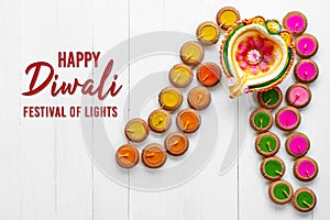 Happy Diwali - Clay Diya lamps lit during Dipavali, Hindu festival of lights celebration. Colorful traditional oil lamp diya on