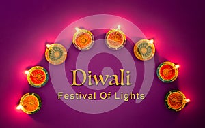 Happy Diwali - Clay Diya lamps lit during Dipavali, Hindu festival of lights celebration. Colorful traditional oil lamp diya on