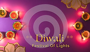 Happy Diwali - Clay Diya lamps lit during Dipavali, Hindu festival of lights celebration. Colorful traditional oil lamp diya on