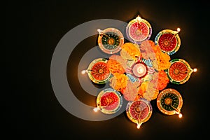 Happy Diwali - Clay Diya lamps lit during Dipavali, Hindu festival of lights celebration. Colorful traditional oil lamp diya on