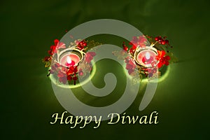 Happy Diwali. Traditional Indian festival green background with burning candles decorated with bright red flowers. Deepavali celeb
