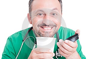 Happy doctor enjoying fresh coffee