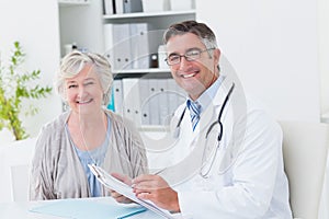 Happy doctor and female patient in clinic