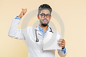 Happy doctor man open envelope take out letter reads, bank loan approve, great news, award, win