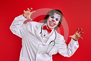 happy doctor mime actor in a white coat and red bow tie