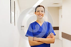 Happy doctor or nurse at hospital corridor