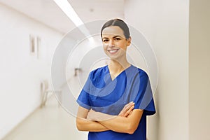 Happy doctor or nurse at hospital corridor