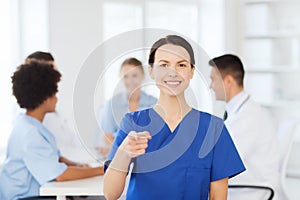 Happy doctor over group of medics at hospital