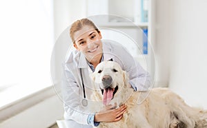 Happy doctor with retriever dog at vet clinic