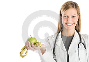 Happy Doctor With Stethoscope Showing Smith Apple And Tape Measure