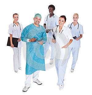 Happy Doctor In Surgical Gown With His Coworkers