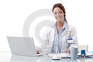Happy doctor using laptop