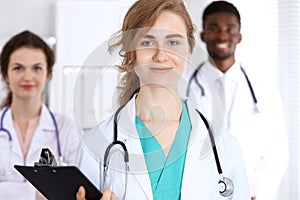 Happy doctor woman with medical staff at the hospital