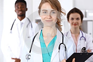 Happy doctor woman with medical staff at the hospital