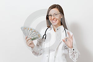 Happy doctor woman with stethoscope showing OK gesture isolated on white background. Female doctor in medical gown