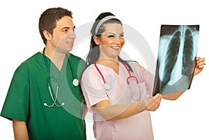 Happy doctors checking X-ray