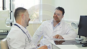 Happy doctors discuss something and laugh