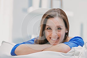 Happy and dreamy woman with crossed arms