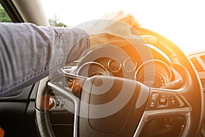 Happy driver inside car at sunset. Young man have fun ride trip travel on road in summer sunny day. Drive vacation