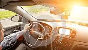 Happy driver inside car at sunset. Young man have fun ride trip travel on road in summer sunny day. Drive vacation concept