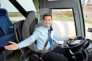 Happy driver inviting on board of intercity bus