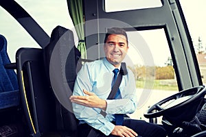 Happy driver inviting on board of intercity bus