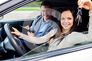 Happy driving student with a car keys