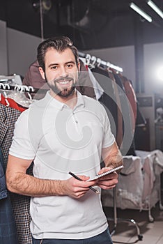 happy dry cleaning worker with notepad