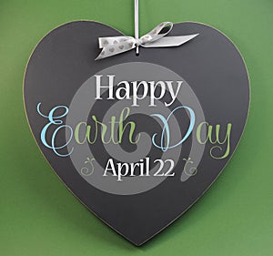 Happy Earth Day April 22, message sign greeting on a heart shaped blackboard