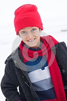 Happy East Indian boy playing in the snow