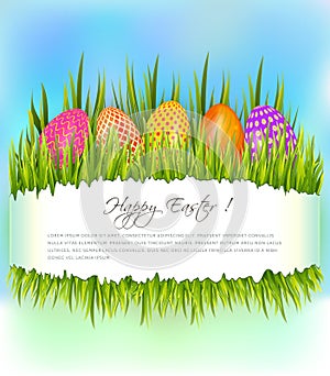 Happy Easter background with set of colorful eggs in grass and copy space.
