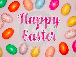 Happy Easter Banner with multiple coloured Easter eggs on a pink background