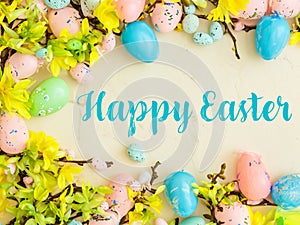 Happy Easter Banner with multiple coloured Easter eggs surrounded by spring flowers