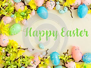 Happy Easter Banner with multiple coloured Easter eggs surrounded by spring flowers