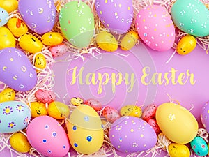 Happy Easter Banner with multiple coloured Easter eggs surrounded by straw