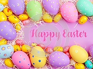 Happy Easter Banner with multiple coloured Easter eggs surrounded by straw